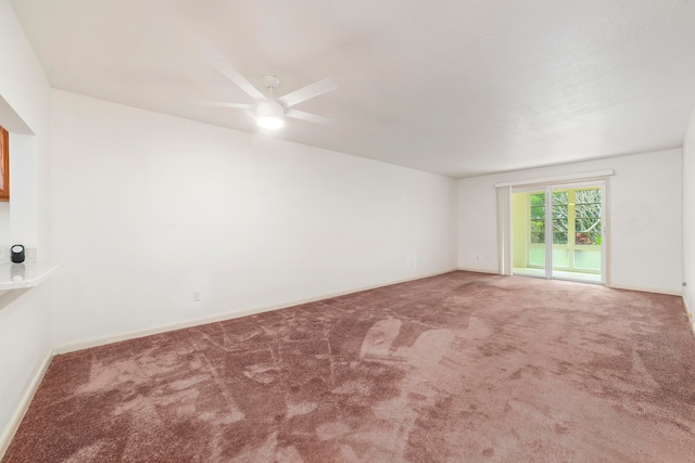 spare room with carpet floors and ceiling fan