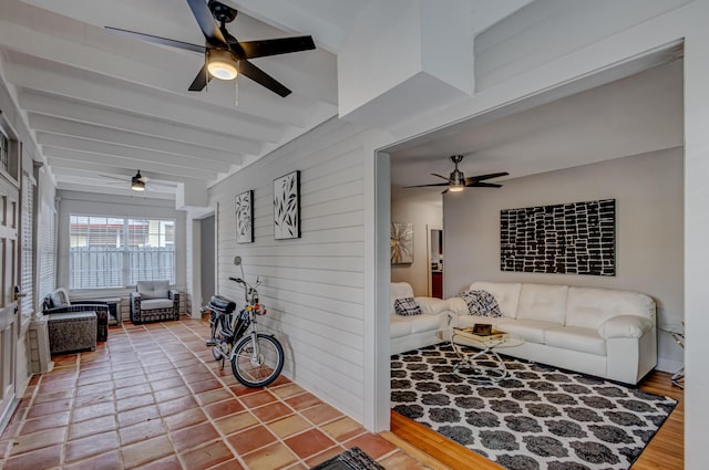 living room featuring beamed ceiling and hardwood / wood-style flooring