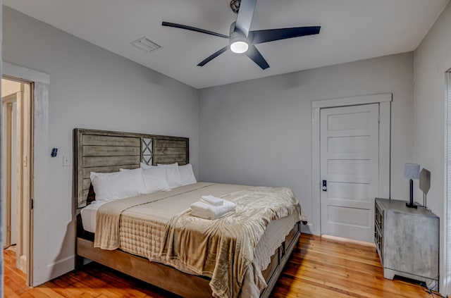 bedroom with ceiling fan and light wood-type flooring