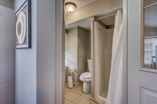 bathroom featuring tile patterned flooring, a shower with curtain, and toilet