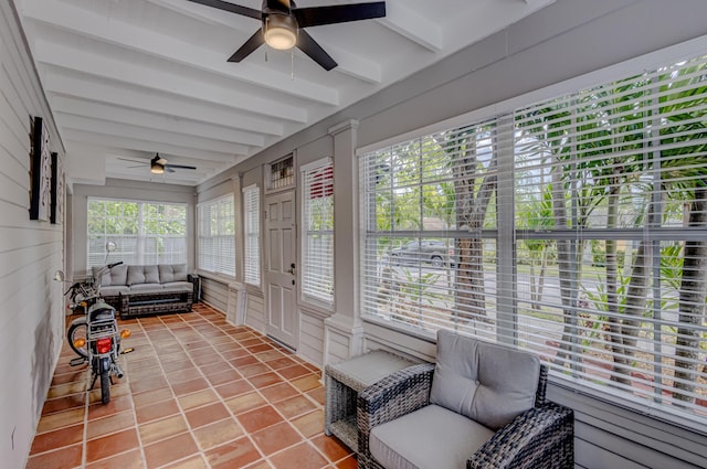 sunroom with ceiling fan and beamed ceiling