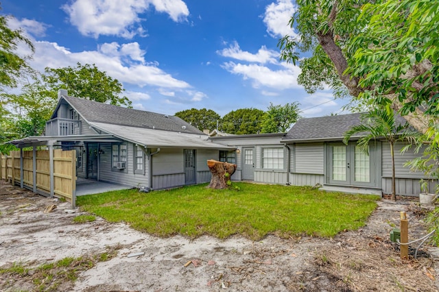 rear view of house featuring french doors, a yard, cooling unit, and a patio area