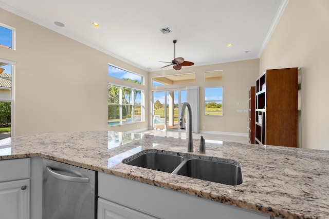 kitchen with white cabinets, ceiling fan, crown molding, and sink