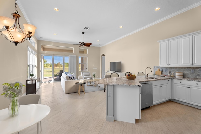 kitchen with backsplash, sink, pendant lighting, dishwasher, and white cabinetry