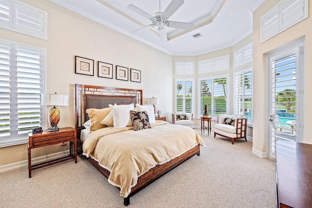 carpeted bedroom with ceiling fan, a raised ceiling, a towering ceiling, access to outside, and ornamental molding