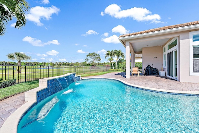 view of pool with a patio area and pool water feature