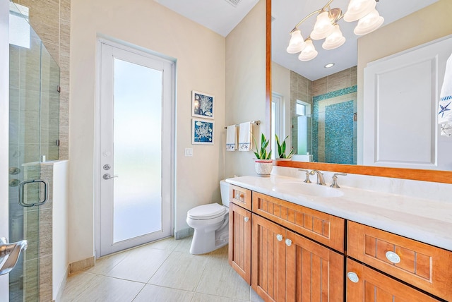 bathroom featuring an inviting chandelier, tile patterned floors, an enclosed shower, toilet, and vanity