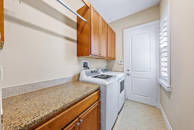 laundry area with cabinets and separate washer and dryer