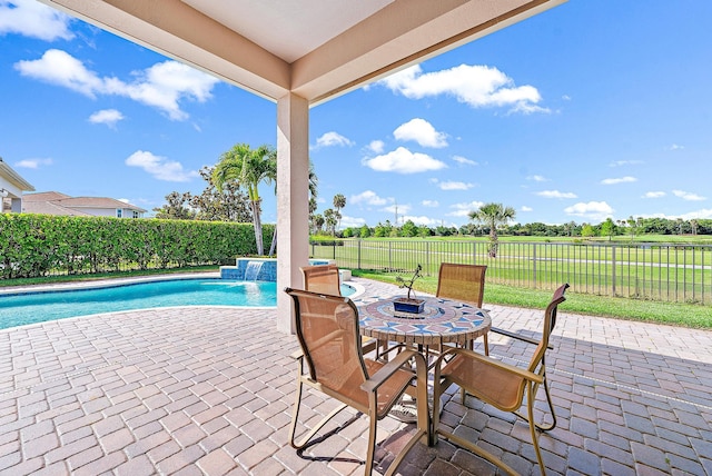 view of patio with a fenced in pool and pool water feature