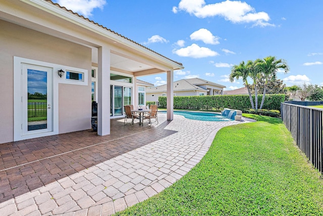 exterior space with pool water feature, a patio, and a lawn