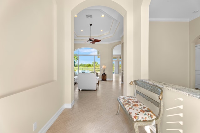 hallway with light tile patterned floors and ornamental molding