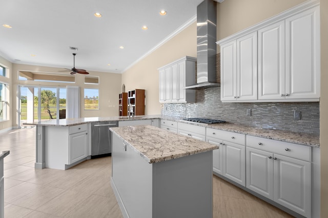 kitchen featuring hanging light fixtures, stainless steel appliances, tasteful backsplash, a textured ceiling, and ornamental molding