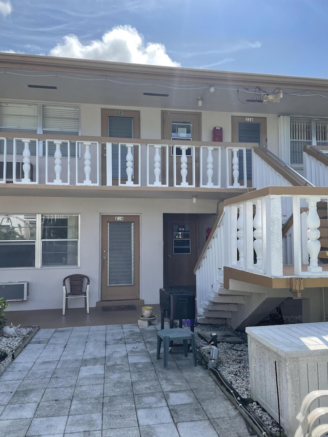 back of house featuring a patio area and a balcony