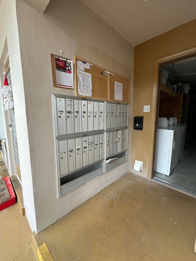 view of property's community featuring mail boxes and washing machine and dryer