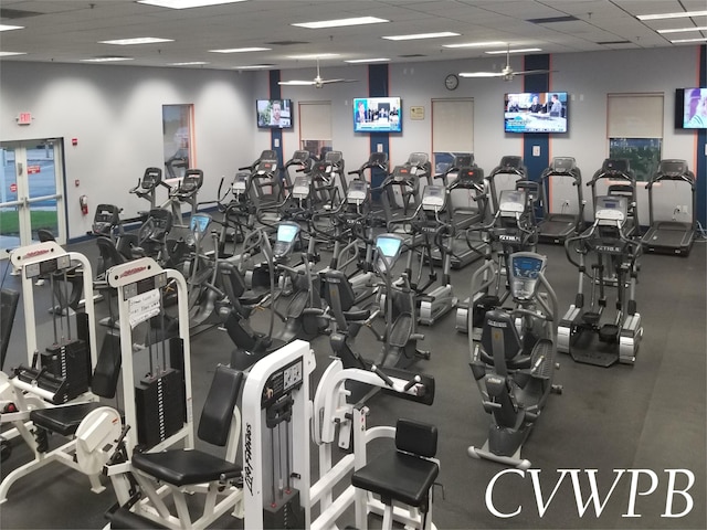 workout area with ceiling fan and a drop ceiling