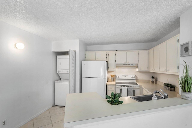 kitchen with a textured ceiling, white appliances, stacked washer / dryer, and sink