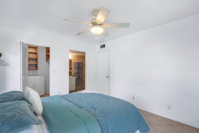 tiled bedroom with a closet and ceiling fan