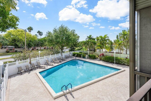 view of swimming pool with a patio