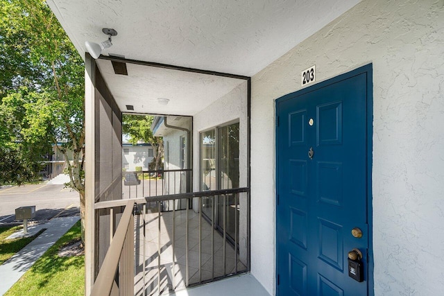 property entrance with covered porch