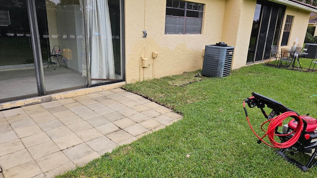 view of yard with a patio and central AC unit