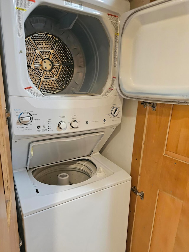 washroom featuring stacked washer / dryer