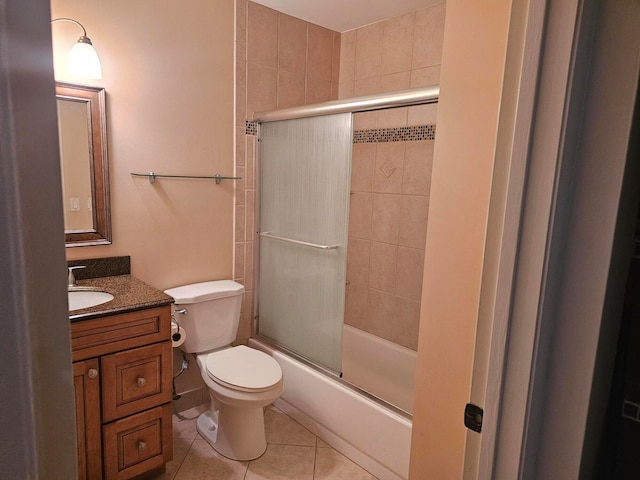 full bathroom with vanity, combined bath / shower with glass door, toilet, and tile patterned flooring