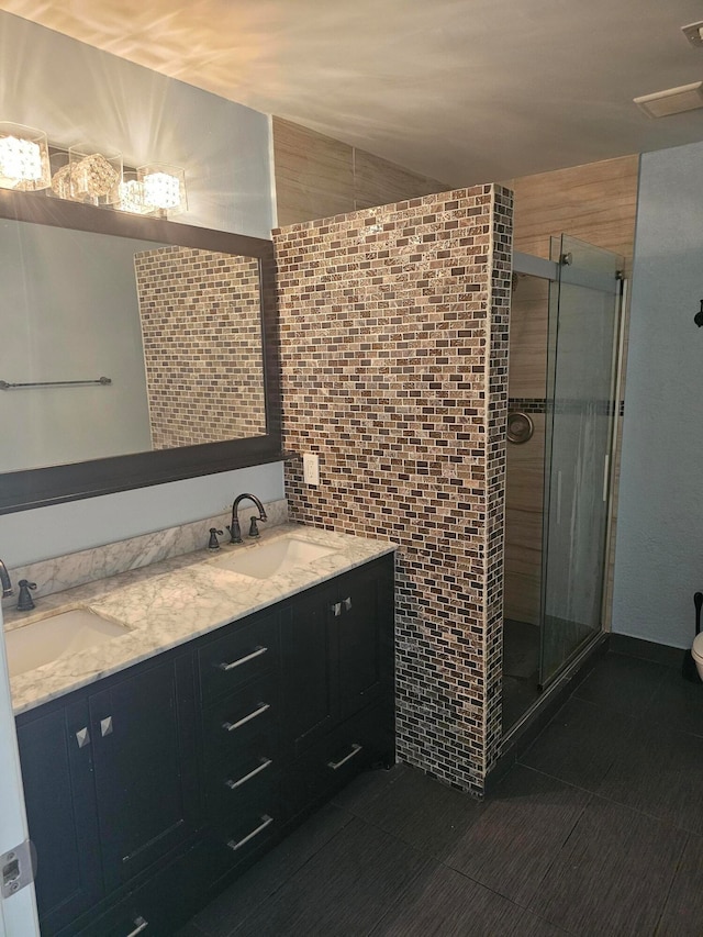 bathroom with vanity, walk in shower, and tile walls