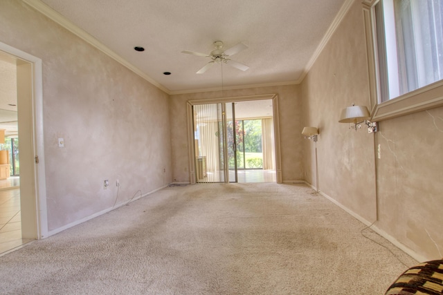 empty room with ceiling fan, carpet flooring, a textured ceiling, and ornamental molding