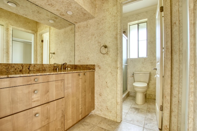 bathroom with vanity, toilet, and tile patterned floors