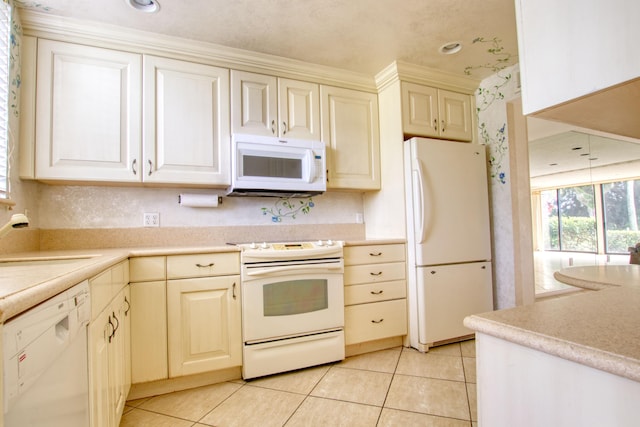 kitchen featuring ornamental molding, sink, light tile patterned flooring, and white appliances