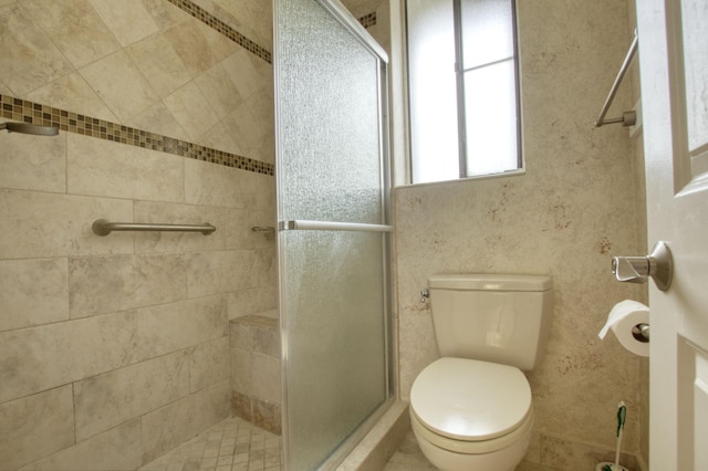 bathroom with toilet and walk in shower