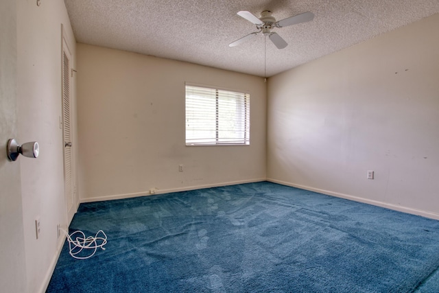 empty room with ceiling fan, a textured ceiling, and carpet flooring