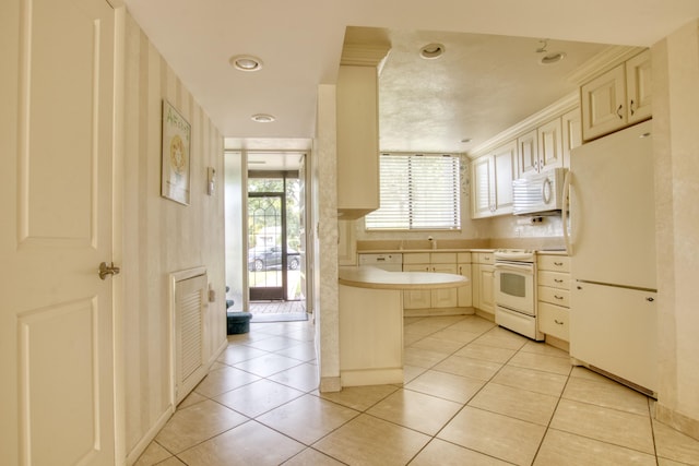 kitchen with cream cabinetry, light tile patterned floors, crown molding, and white appliances