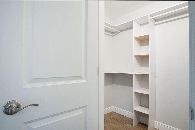 bathroom with a shower with door, vanity, and toilet