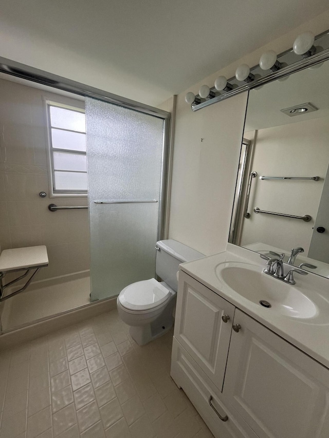 bathroom featuring tile floors, an enclosed shower, toilet, and oversized vanity