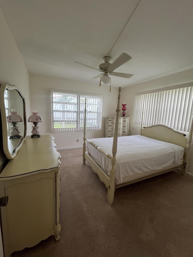 bedroom featuring ceiling fan and dark colored carpet