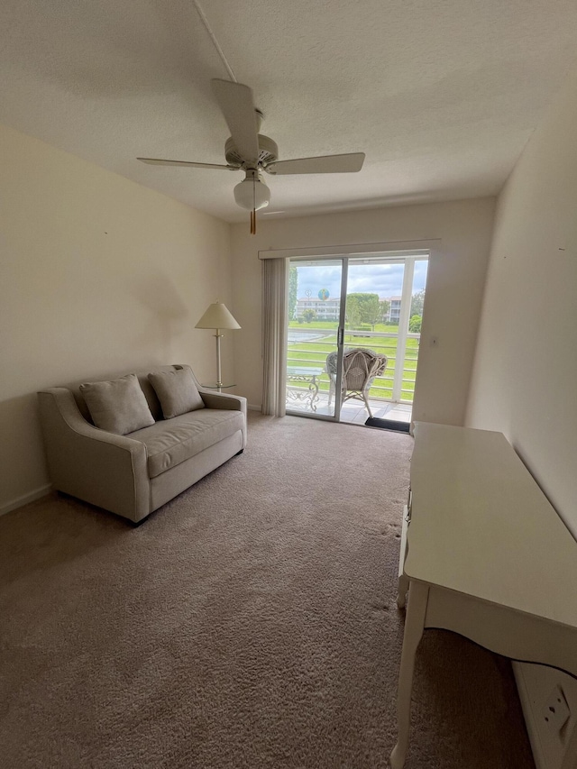 unfurnished living room with ceiling fan and carpet flooring