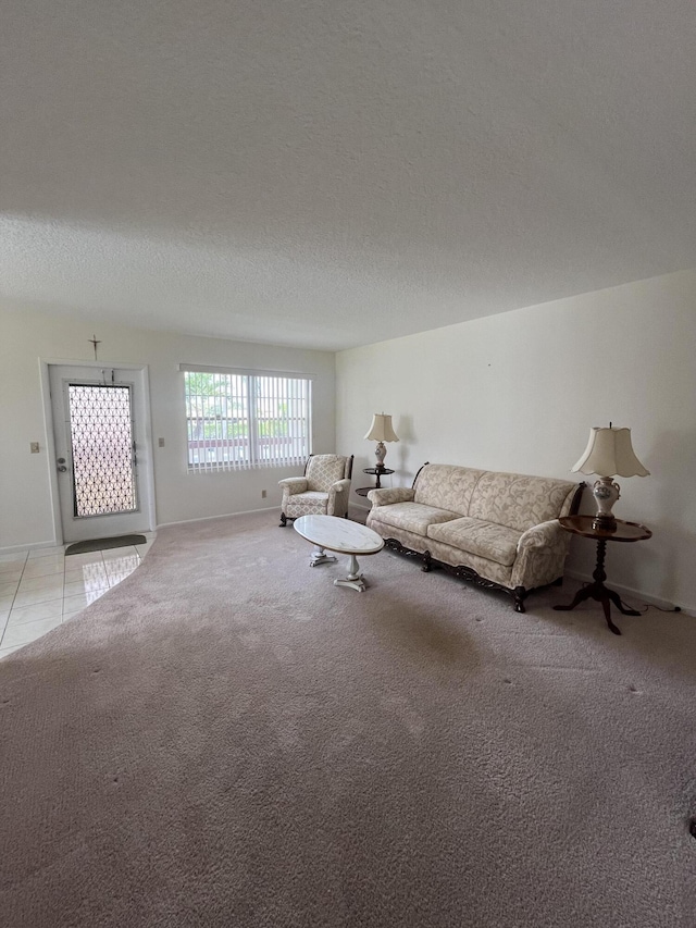 unfurnished living room with carpet and a textured ceiling