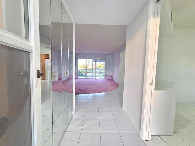 corridor featuring light tile flooring