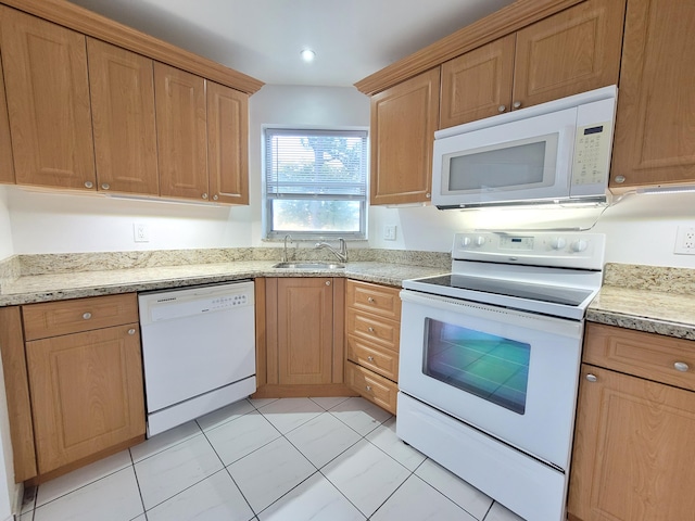 kitchen with sink, white appliances, light tile floors, and light stone countertops