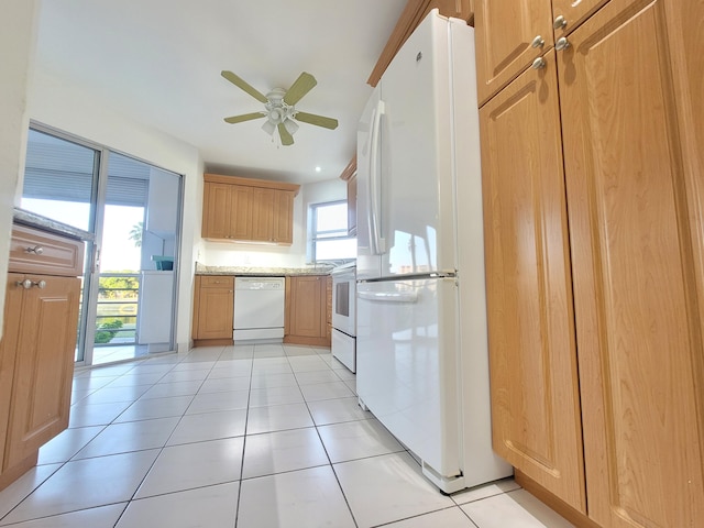 kitchen featuring plenty of natural light, ceiling fan, white appliances, and light tile flooring