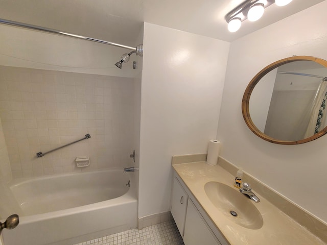 bathroom with vanity with extensive cabinet space, tiled shower / bath combo, and tile floors