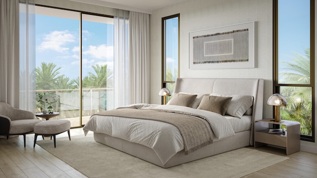 bedroom featuring access to outside, light hardwood / wood-style flooring, and multiple windows