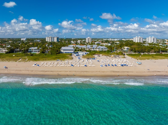 drone / aerial view featuring a water view and a beach view