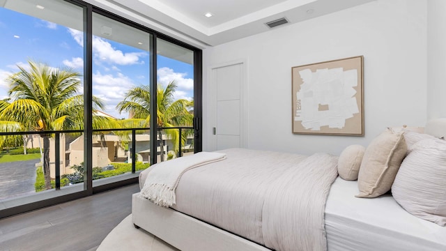 bedroom featuring access to exterior and hardwood / wood-style flooring