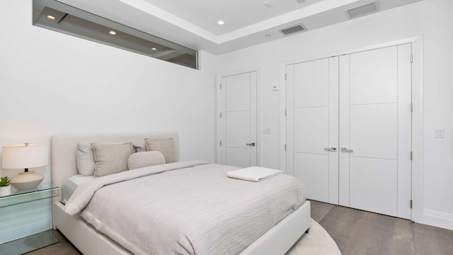 bedroom featuring a closet and dark hardwood / wood-style flooring