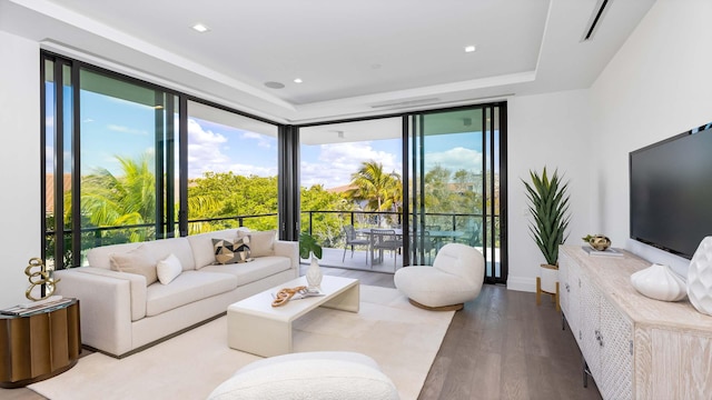 living room featuring floor to ceiling windows and hardwood / wood-style flooring