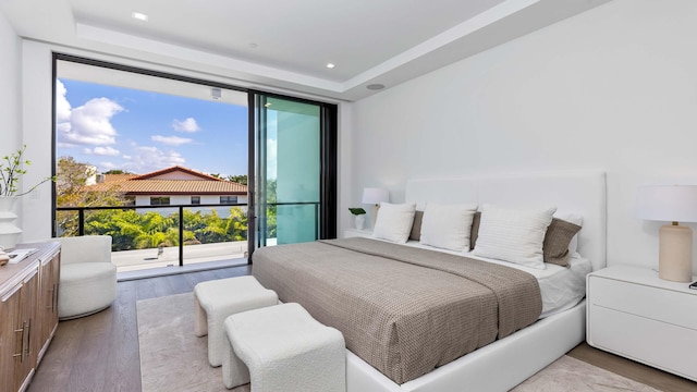 bedroom featuring access to exterior and hardwood / wood-style floors