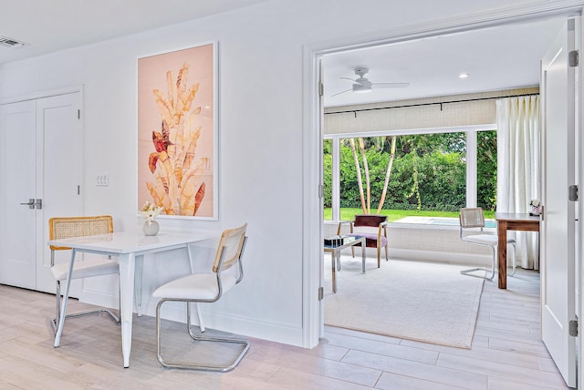 dining room with light hardwood / wood-style floors and ceiling fan