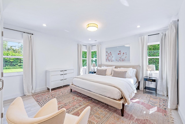 bedroom featuring hardwood / wood-style flooring and multiple windows